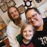 Andrew Artman with his wife Amanda and their son