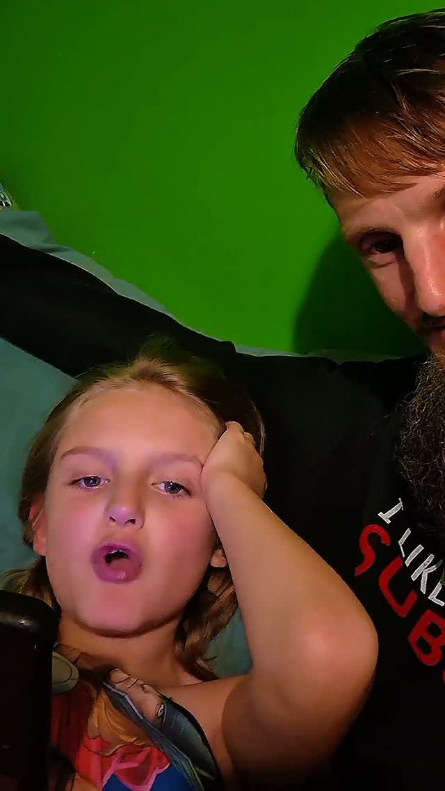 Andrew and his son making faces together in front of a green screen