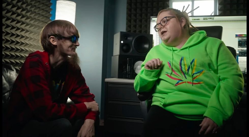Andrew and his wife Amanda talking together in a recording studio